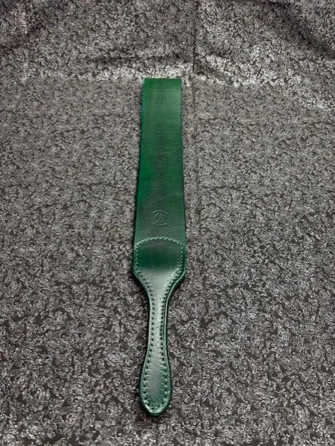 Green leather strap on a textured gray surface